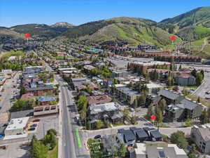 Aerial perspective showcasing the surrounding mountainous terrain and urban landscape