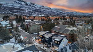 Snowy aerial view with a mountain view and a residential view