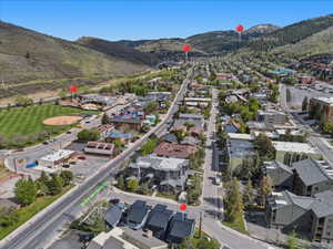 Aerial overview showcasing a developed urban area bordered by tree-covered mountains