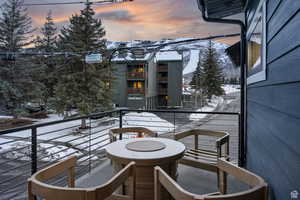 View of snow covered back of property