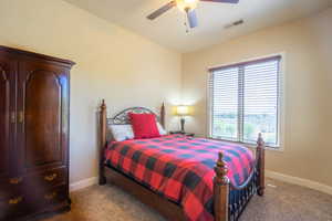 Carpeted bedroom with baseboards and ceiling fan
