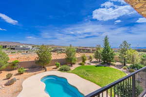 View of pool featuring a fenced backyard, a mountain view, and patio surround