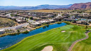 Aerial view of residential area featuring a water and mountain view and a golf club