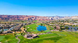 Aerial perspective of suburban area with a golf club and a water and mountain view