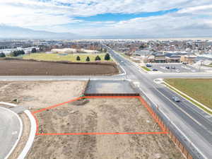 Aerial view of property's location with property boundaries highlighted and a mountainous background