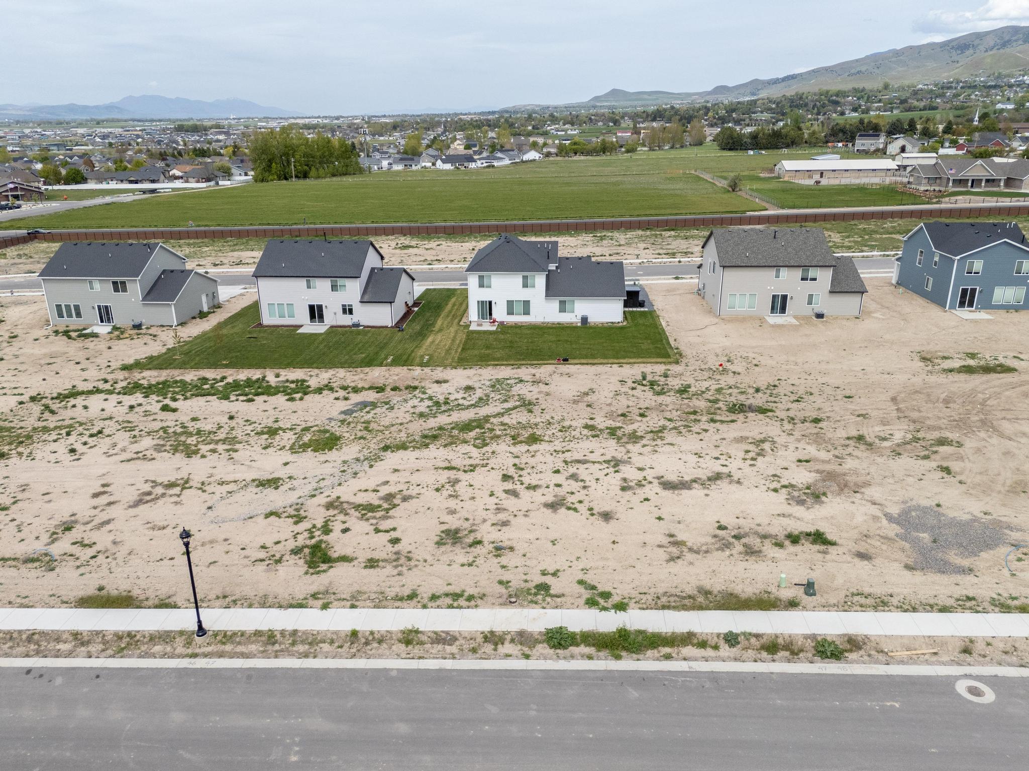 Aerial perspective of suburban area featuring a mountain backdrop