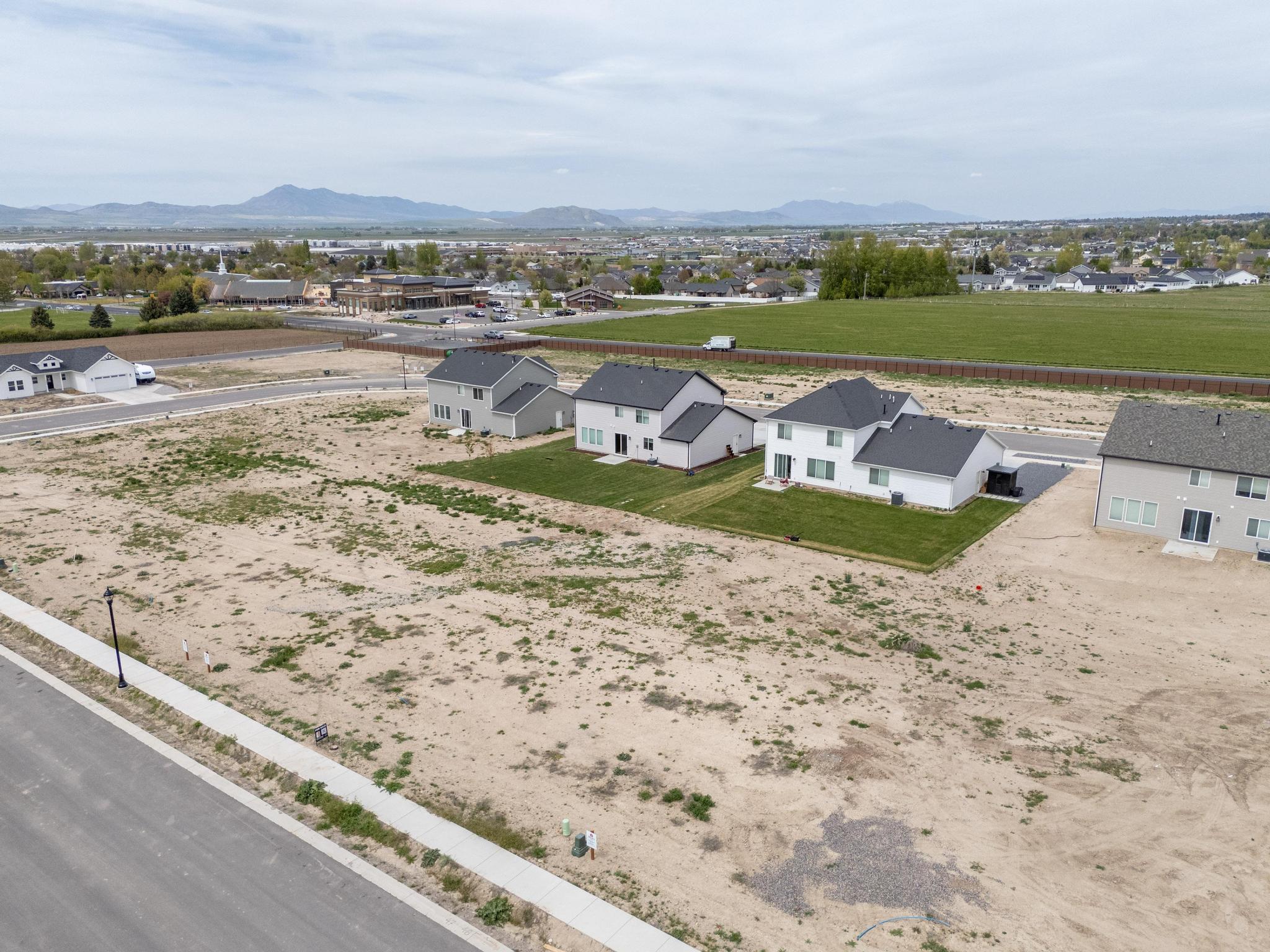 Aerial view of residential area featuring a mountainous background
