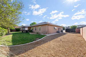 Rear view of property featuring a fenced backyard, a patio area, and stucco siding