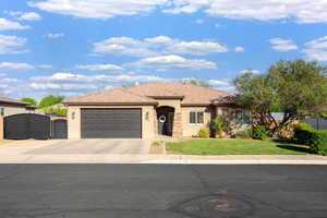 Single story home featuring a gate, stucco siding, a garage, and concrete driveway