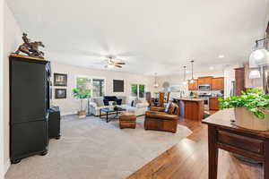 Living room featuring light wood-type flooring, recessed lighting, and a ceiling fan