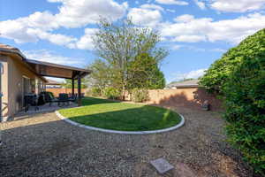 Fenced backyard with a patio
