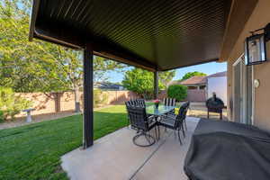Fenced backyard with a patio area, outdoor dining area, and area for grilling