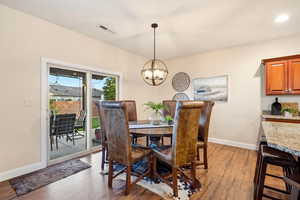 Dining space featuring light wood-type flooring and suspended lighting