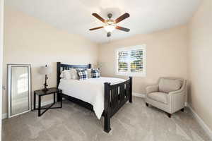 Bedroom featuring light carpet and ceiling fan