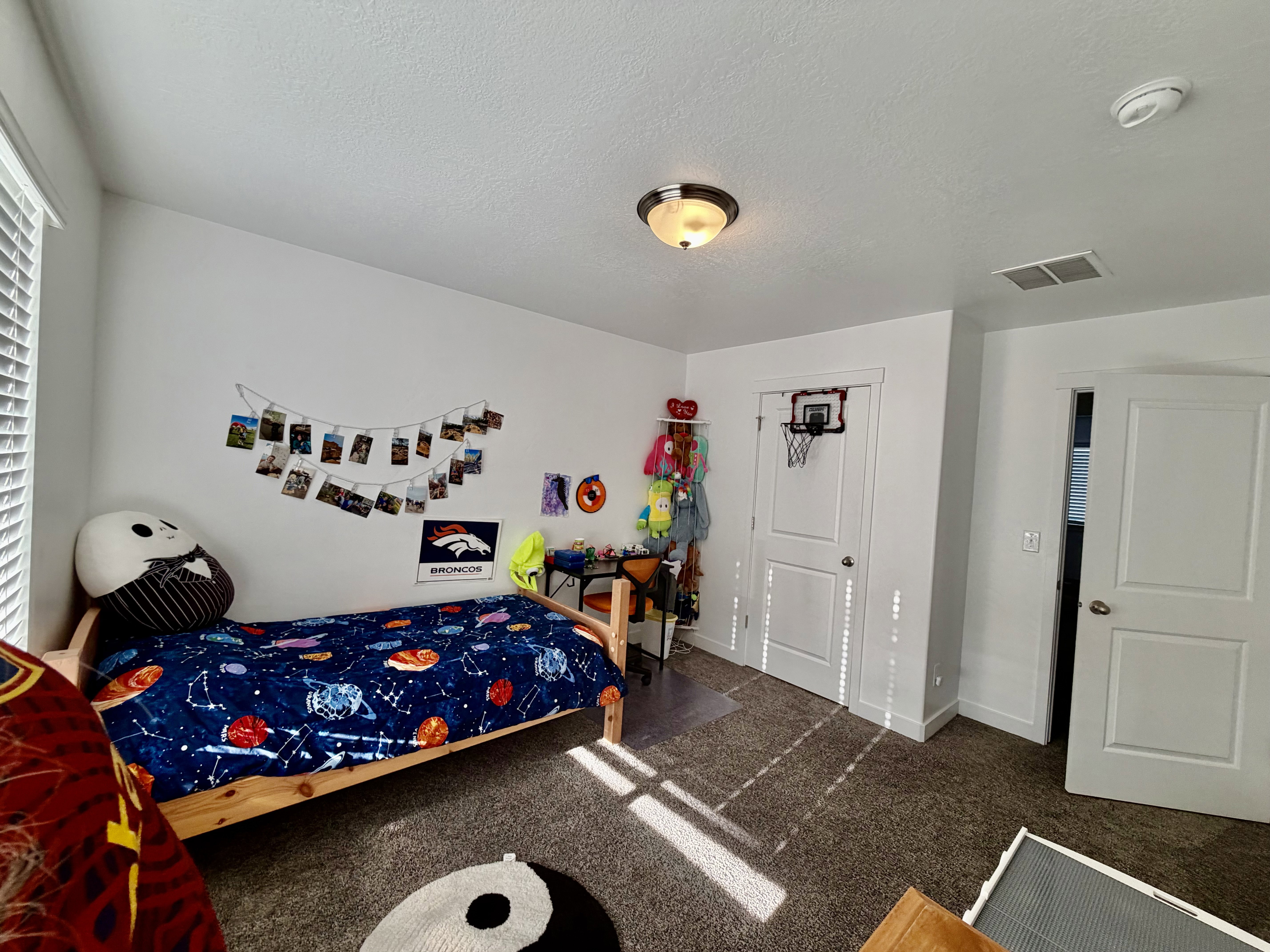 Bedroom with dark carpet and a textured ceiling