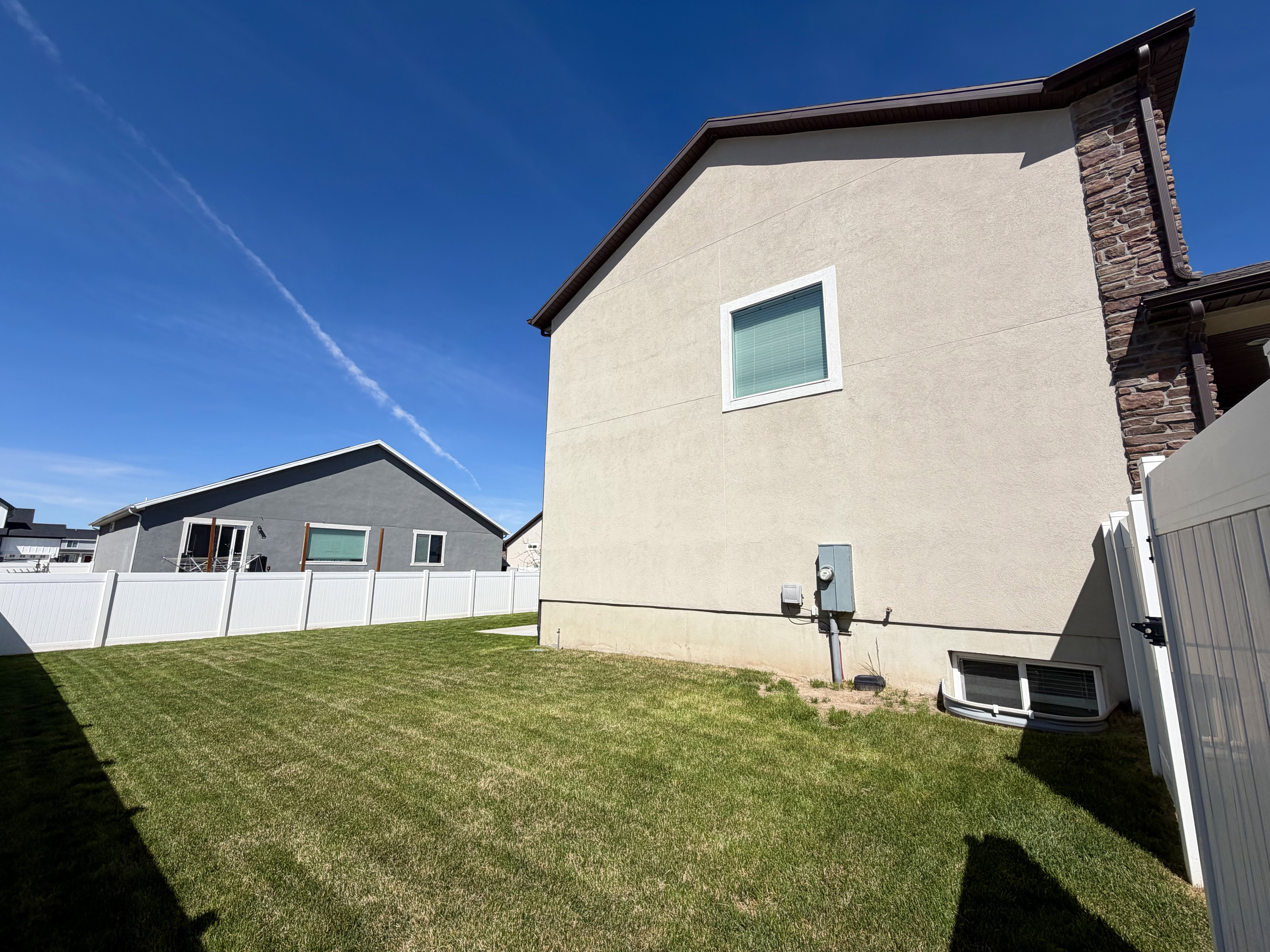 View of side of property featuring stucco siding