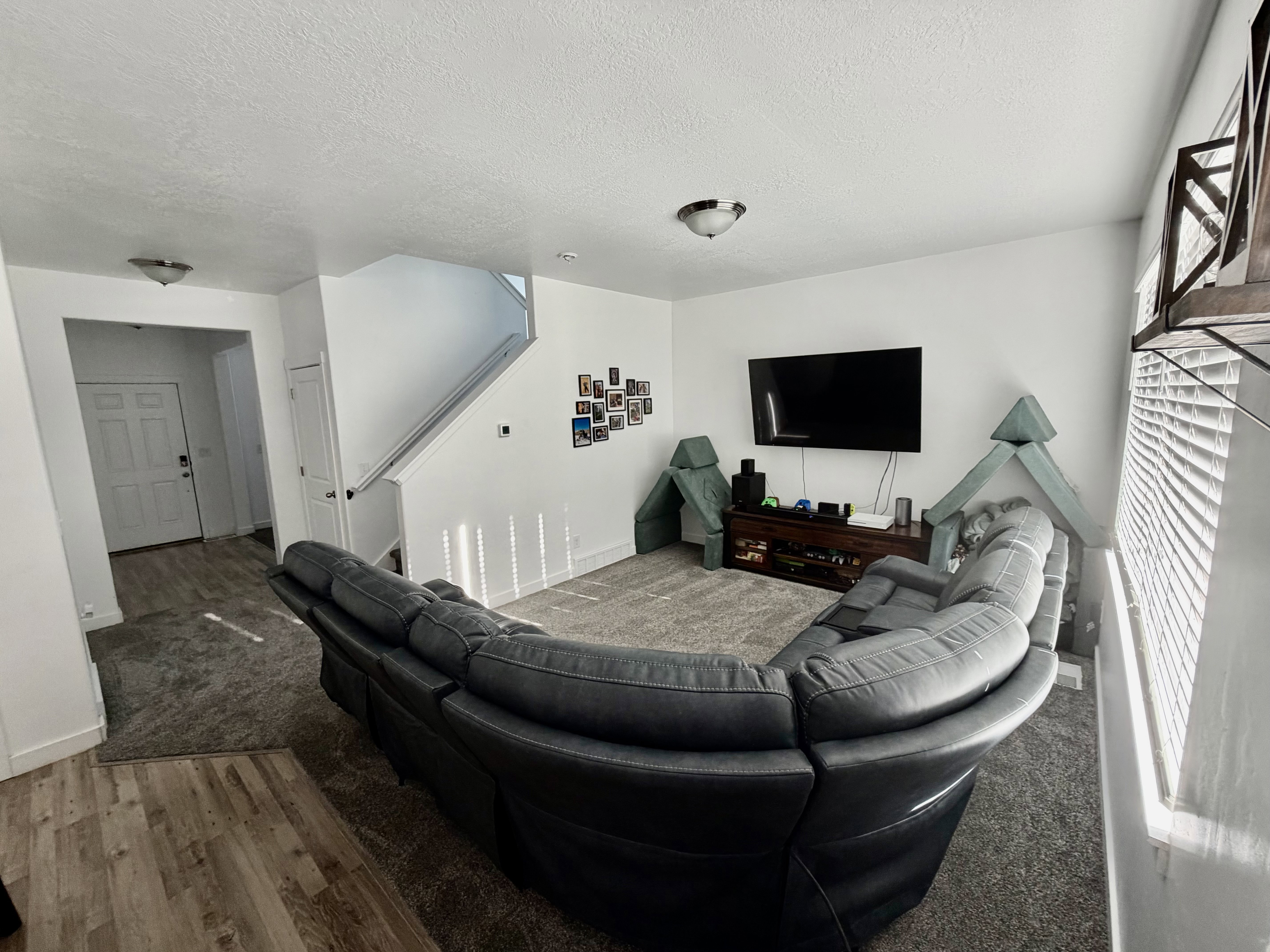 Living area with wood finished floors and a textured ceiling