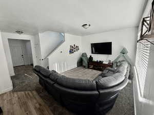 Living area with wood finished floors and a textured ceiling