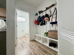 Mudroom with light wood-style floors and baseboards