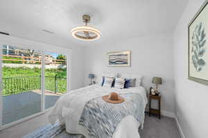 Bedroom with carpet floors and access to exterior
