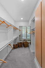 Walk in closet featuring light carpet