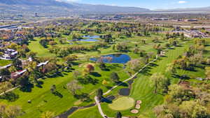 Aerial view of residential area featuring a water and mountain view and a golf club