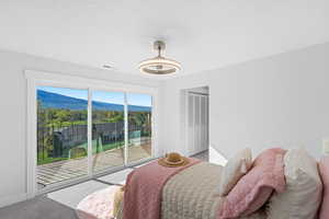 Bedroom featuring a mountain view, carpet flooring, a closet, and access to outside