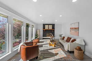 Living area featuring a fireplace, recessed lighting, and wood finished floors