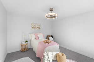 Bedroom featuring carpet flooring and baseboards