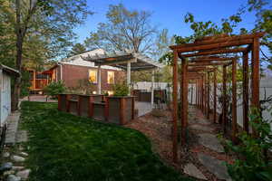 Fenced backyard featuring a pergola and a patio area