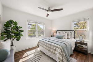 Bedroom with dark wood-style flooring and a ceiling fan