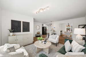 Living room with wood finished floors and track lighting