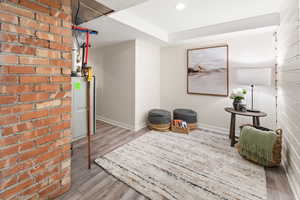 Living area featuring light wood-style floors and baseboards