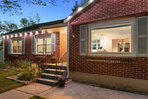 Doorway to property featuring brick siding