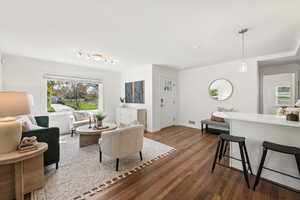 Living room featuring dark wood-style floors and plenty of natural light