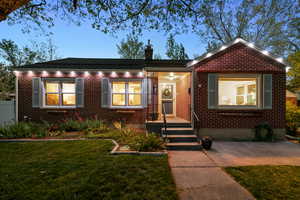 Bungalow featuring brick siding and a chimney