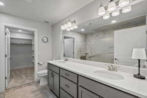 Primary Bathroom, quartz countertops walk in closet, double vanity and cabinets with upgraded height.