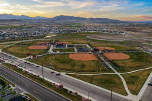 Aerial view of property and surrounding area with a mountain backdrop