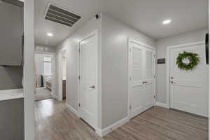 Hallway from kitchen, leading to laundry, garage, utility and full bathroom