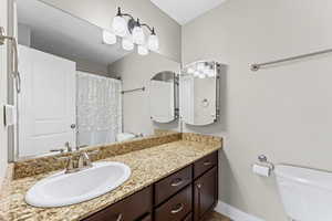 Bathroom featuring vanity and curtained shower