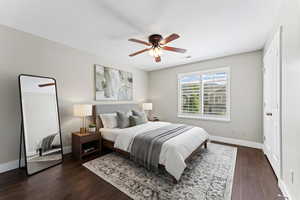Bedroom with dark wood-style flooring and ceiling fan
