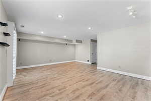 Below grade area featuring light wood-style floors and baseboards