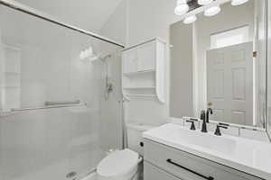 Bathroom featuring vanity and a stall shower
