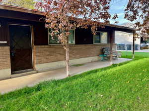 Property entrance featuring brick siding