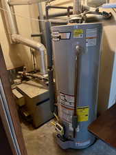 Utilities featuring gas water heater and a heating unit