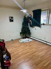 Spare room featuring baseboard heating and light wood finished floors