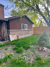 View of property exterior featuring brick siding and a chimney