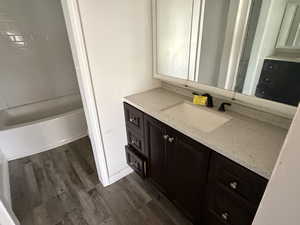 Bathroom featuring vanity and dark wood finished floors