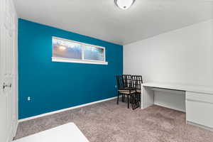 Bedroom with light colored carpet and baseboards