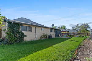 Rear view of property featuring brick siding